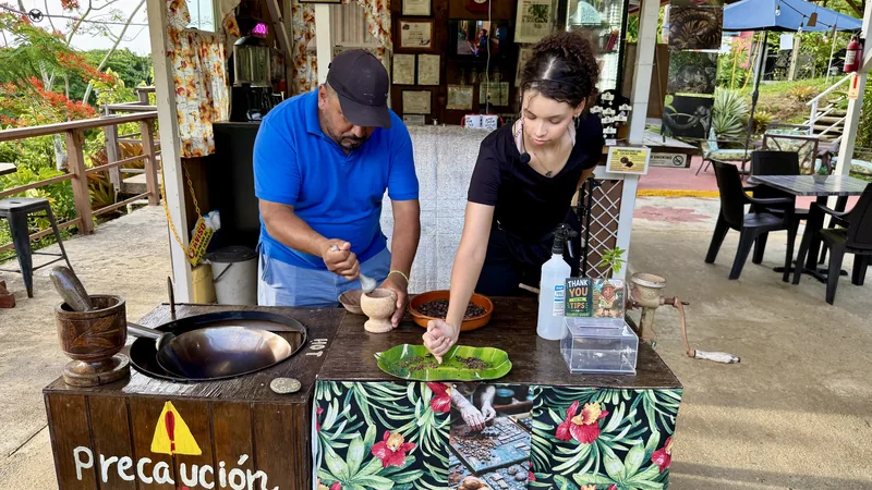 Grinding roasted cacao beans for the chocolate tasting at an organic cacao farm in Luquillo, Puerto Rico