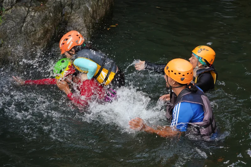 Guests floating a whirlpool pool in safety gear, south side of El Yunque, Puerto Rico