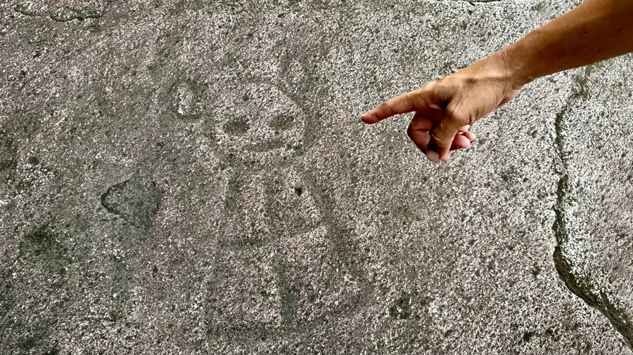 Ancient Taino petroglyphs carved into river rocks at Charco El Hippie