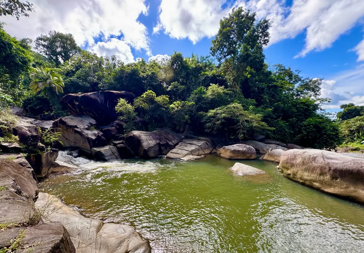 Natural swimming pools at Charco El Hippie with jungle and blue sky
