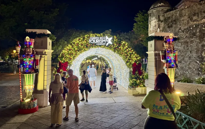 Arch of Christmas lights with nutcracker soldiers beside the old city walls of Old San Juan, where the Christmas tour begins