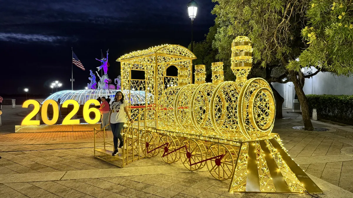 Light-up Christmas train and glowing photo spots on the waterfront promenade in Old San Juan