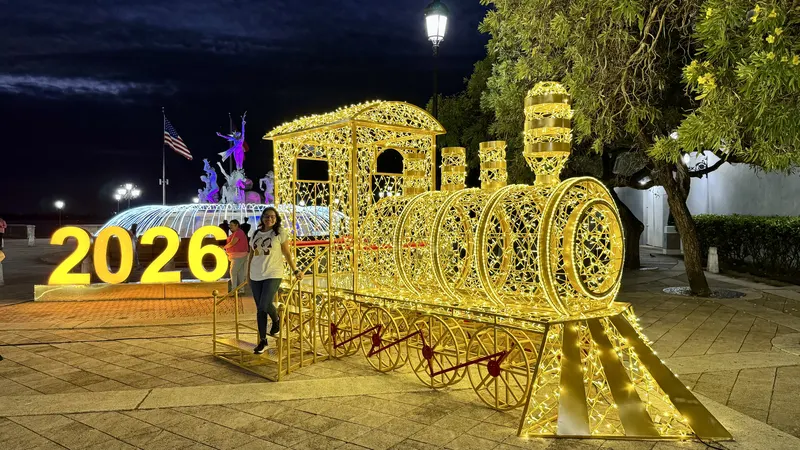 Light-up Christmas train and glowing photo spots on the waterfront promenade in Old San Juan