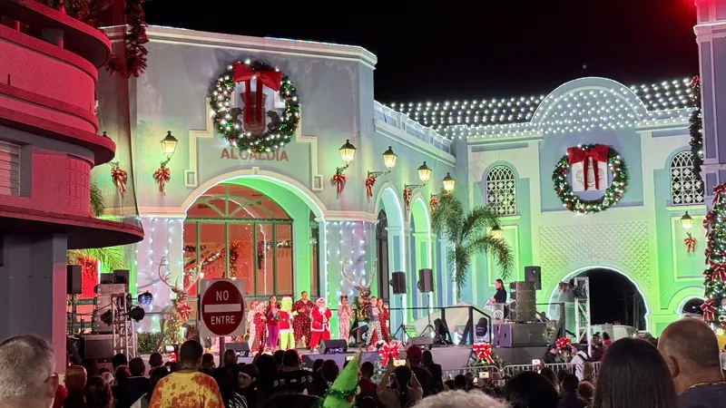 Christmas concert on the plaza in front of a town hall decorated with wreaths and lights in Puerto Rico